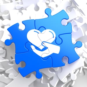 Charity Concept - Icon of Heart in the Hand - Located on Blue Puzzle Pieces. Social Background.-1
